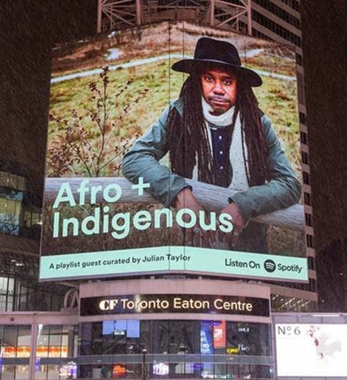 “Afro + Indigenous” Artist Julian Taylor Adorns The Spotify Billboard At Toronto’s Dundas Square